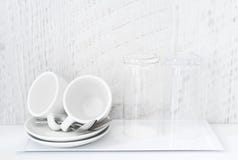 Kaffe och te som gör uppsättningen av vita koppar, tefat, teskedar och exponeringsglas på det vita porslinmagasinet Hotellboende arkivfoton Kaffe och te som gör uppsättningen av vita koppar, tefat, teskedar och exponeringsglas på det vita porslinmagasinet Hotellboende arkivfoton