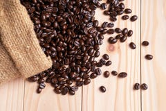 Kaffebönor som är utspillda från linnesäcken royaltyfri foto Kaffebönor som är utspillda från linnesäcken royaltyfri foto