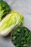 Kale, chinese cabbage, broccoli on a gray background. Top view, copy space for text, selective focus royalty free stock photos Kale, chinese cabbage, broccoli on a gray background. Top view, copy space for text, selective focus royalty free stock photos