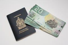 Kanadischer Paß mit Dollarscheinen lizenzfreie stockbilder Kanadischer Paß mit Dollarscheinen lizenzfreie stockbilder