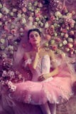 Young woman in pink ballet tutu surrounded by flowers royalty free stock photography Young woman in pink ballet tutu surrounded by flowers royalty free stock photography