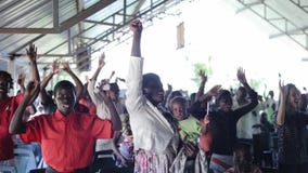 KENYA, KISUMU - MAY 20, 2017: Big group of african and caucasian people, children dancing together. stock video footage KENYA, KISUMU - MAY 20, 2017: Big group of african and caucasian people, children dancing together. stock video footage