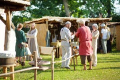 KERNAVE, LITHUANIA - JULY 6, 2018: Historical reenactment activists wearing medieval costumes during annual Festival of stock images KERNAVE, LITHUANIA - JULY 6, 2018: Historical reenactment activists wearing medieval costumes during annual Festival of stock images