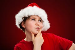 Kerstmistijd - jongen met Santa Claus Hat royalty-vrije stock fotografie Kerstmistijd - jongen met Santa Claus Hat royalty-vrije stock fotografie
