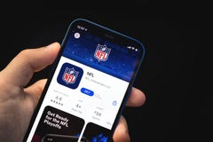 Kharkov, Ukraine - June 4, 2021: NFL app, man holds mobile phone with application on the screen