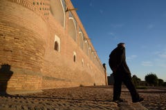 Old man walking at sunset in the old town. Itchan Kala. Khiva. Uzbekistan royalty free stock images Old man walking at sunset in the old town. Itchan Kala. Khiva. Uzbekistan royalty free stock images