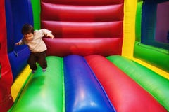 Kid jumping in inflatable playground