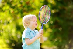 Kid playing badminton in summer park Stock Images Kid playing badminton in summer park Stock Images