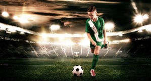 Kid - soccer player. Boy forward in football sportswear on stadium with ball. Sport concept. royalty free stock image Kid - soccer player. Boy forward in football sportswear on stadium with ball. Sport concept. royalty free stock image