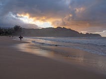 Kid surfer holding bodyboard leaving ocean at sunset royalty free stock images Kid surfer holding bodyboard leaving ocean at sunset royalty free stock images
