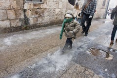 Kid Walking In Jerusalem Snowfall Royalty Free Stock Image