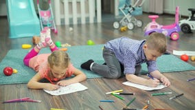 Kids drawing with pencils and felt pens at home