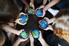 Kids hands holding cupping globe balls together Stock Photography Kids hands holding cupping globe balls together Stock Photography