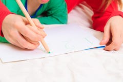 Kids learning - hands of mother and child writing numbers stock photography Kids learning - hands of mother and child writing numbers stock photography