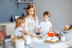 Kids making cookies in the kitchen. stock photo Kids making cookies in the kitchen. stock photo