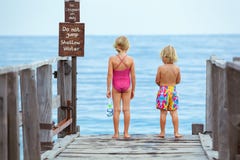 Kids with masks, fins going to snorkel in tropical sea royalty free stock image Kids with masks, fins going to snorkel in tropical sea royalty free stock image