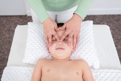 Kids Massage Concept Background. Female Therapist Giving A Young Boy Face Massage. Top View. Stock Image