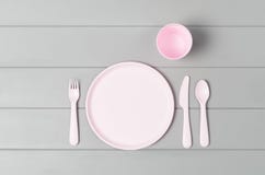 Kids Pastel Plastic Tableware Isolated On Gray Background. Top View Stock Photography Kids Pastel Plastic Tableware Isolated On Gray Background. Top View Stock Photography