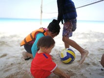 Kids playing ball by the beach in Pulau Redang. royalty free stock photo Kids playing ball by the beach in Pulau Redang. royalty free stock photo