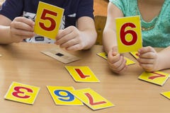 Kids are playing. Educational games. A child in kindergarten. The hands of a child. Maths. Cards for development royalty free stock photos Kids are playing. Educational games. A child in kindergarten. The hands of a child. Maths. Cards for development royalty free stock photos