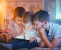Kids playing games on tablet pc. Three little boys with tablet computer stock images Kids playing games on tablet pc. Three little boys with tablet computer stock images