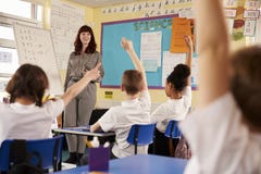 Kids raising hands in a primary school class, low angle view royalty free stock photos Kids raising hands in a primary school class, low angle view royalty free stock photos