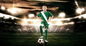 Kid - soccer player. Boy forward in football sportswear on stadium with ball. Sport concept. royalty free stock photography Kid - soccer player. Boy forward in football sportswear on stadium with ball. Sport concept. royalty free stock photography