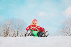Kids winter fun- little girl enjoy sliding in snow stock image Kids winter fun- little girl enjoy sliding in snow stock image