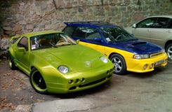 Kiev, 2010 September 14; Porsche 928 Raptor in lush green and Subaru STI royalty free stock photography Kiev, 2010 September 14; Porsche 928 Raptor in lush green and Subaru STI royalty free stock photography