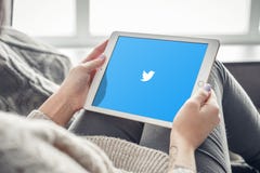 Woman using Twitter app on a brand new Apple iPad Pro royalty free stock image Woman using Twitter app on a brand new Apple iPad Pro royalty free stock image
