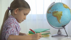 Kind, das Erdkugel, Mädchen schreibt für die Schule im Büro, Kind lernend studiert lizenzfreies stockfoto Kind, das Erdkugel, Mädchen schreibt für die Schule im Büro, Kind lernend studiert lizenzfreies stockfoto
