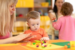 Kindergarten kid learning with teacher in nursery stock images Kindergarten kid learning with teacher in nursery stock images