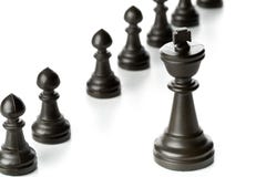 King chess figure in front of row of pawn chess figures royalty free stock photo King chess figure in front of row of pawn chess figures royalty free stock photo