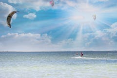 Kitesurfing. Girl rides a kite at sunny day royalty free stock photos Kitesurfing. Girl rides a kite at sunny day royalty free stock photos