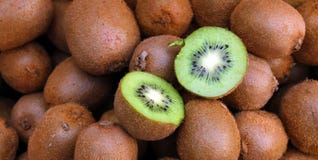 Kiwi. Fresh organic kiwis in knitted basket. Slice of colorful green kiwi fruit with seeds. Fruits background texture. Kiwi wallpa stock photography Kiwi. Fresh organic kiwis in knitted basket. Slice of colorful green kiwi fruit with seeds. Fruits background texture. Kiwi wallpa stock photography