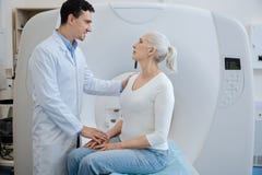 Knappe blije arts die zijn patiënt een diagnose vertellen royalty-vrije stock afbeeldingen Knappe blije arts die zijn patiënt een diagnose vertellen royalty-vrije stock afbeeldingen