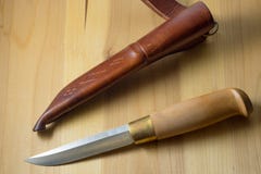 Knife handmade with a wooden handle knife in leather brown scabbard stock photography Knife handmade with a wooden handle knife in leather brown scabbard stock photography
