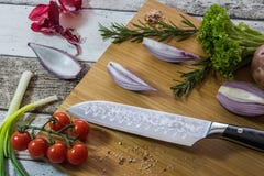 Knife with healthy food - vegetables, onion, salad, tomatoes, potato placed on a cutting board with wood background top view stock image Knife with healthy food - vegetables, onion, salad, tomatoes, potato placed on a cutting board with wood background top view stock image