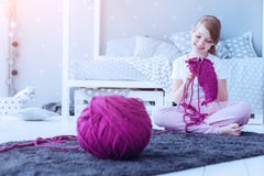Smart curious girl knitting warm scarf at home royalty free stock photography Smart curious girl knitting warm scarf at home royalty free stock photography