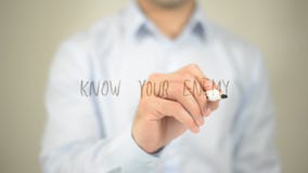 Know Your Enemy , man writing on transparent screen royalty free stock photo Know Your Enemy , man writing on transparent screen royalty free stock photo