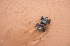 Kolyazin, Moscow region / Russian Federation - May 1 2014: RC car crowler Vaterra Twin Hammers driving through the sand royalty free stock image Kolyazin, Moscow region / Russian Federation - May 1 2014: RC car crowler Vaterra Twin Hammers driving through the sand royalty free stock image