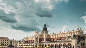 Krakow, Poland. Main Market Square In Cloudy Summer Day. Famous Landmark. Unesco World Heritage Site stock video footage Krakow, Poland. Main Market Square In Cloudy Summer Day. Famous Landmark. Unesco World Heritage Site stock video footage