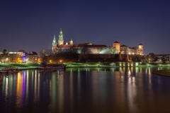 Krakow, Poland, Wawel Castle and Wawel cathedral over Vistula river in the night. Travel