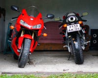 KRASNOYARSK, RUSSIA - September 3, 2018: Two sportbikes in the garage. Red and black sportbike Honda CBR 600 RR 2005 PC37 royalty free stock photography KRASNOYARSK, RUSSIA - September 3, 2018: Two sportbikes in the garage. Red and black sportbike Honda CBR 600 RR 2005 PC37 royalty free stock photography