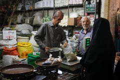 Famous Iranian market bazaar and a woman in a black chodor buy products stock image Famous Iranian market bazaar and a woman in a black chodor buy products stock image