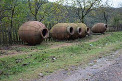 Kvevri, Clay jugs for winemaking near the fence stock images Kvevri, Clay jugs for winemaking near the fence stock images