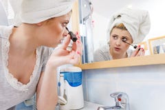 Kvinna i badrummet som applicerar mascara p? ?gonfrans royaltyfri foto Kvinna i badrummet som applicerar mascara p? ?gonfrans royaltyfri foto