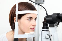 Kvinna som gör synförmågamätning med den optiska slitslampan royaltyfria foton Kvinna som gör synförmågamätning med den optiska slitslampan royaltyfria foton