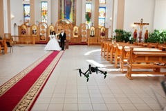 Kyiv, Ukraine - August 31: DJI Inspire Pro drone quadcopter recording on video wedding couple on church at wedding day.