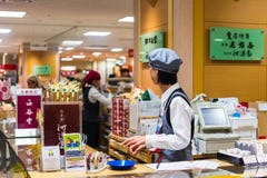 KYOTO, JAPAN - NOVEMBER 7, 2017: Worker at the ticket office at royalty free stock photo KYOTO, JAPAN - NOVEMBER 7, 2017: Worker at the ticket office at royalty free stock photo